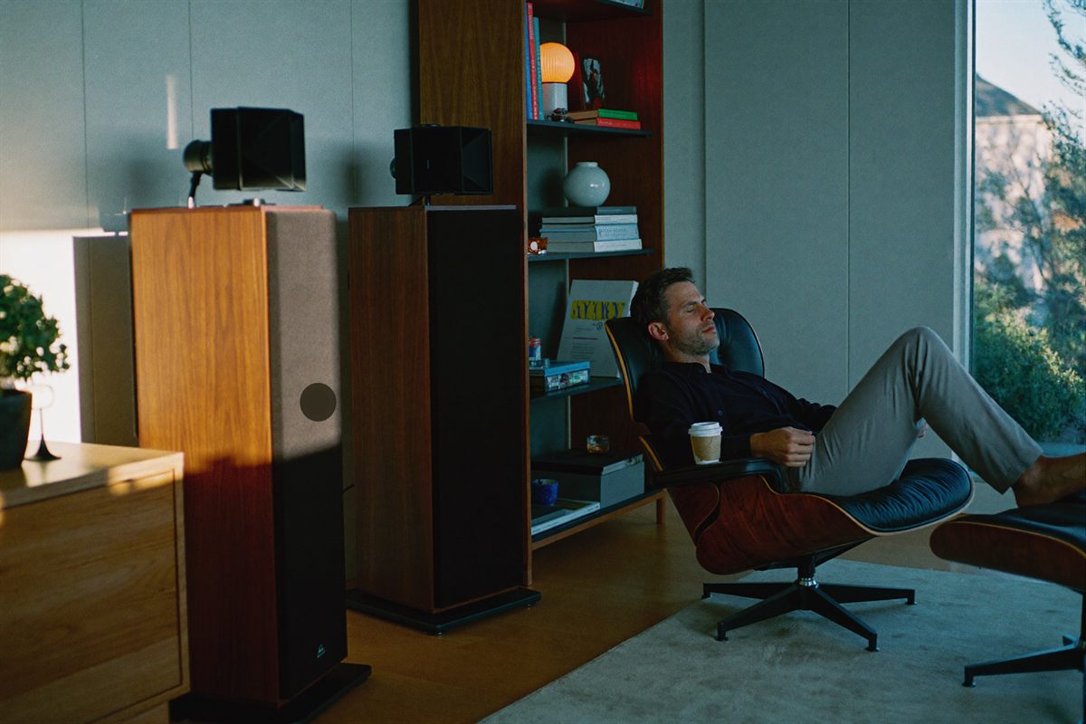 A calm listening corner with floor-standing speakers either side of a low cabinet in soft morning light